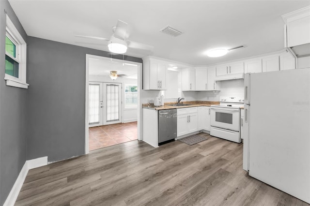 629 Lexington St, Dunedin, FL 34698 - kitchen featuring white appliances, white cabinets, and a ceiling fan