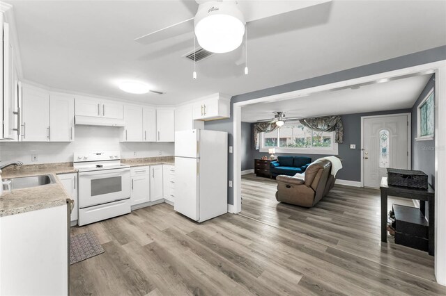 629 Lexington St, Dunedin, FL 34698 - kitchen featuring white appliances, a ceiling fan, open floor plan, light countertops, and under cabinet range hood