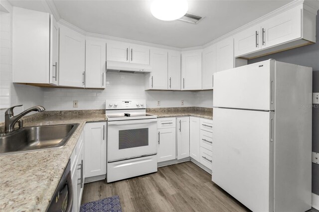 629 Lexington St, Dunedin, FL 34698 - kitchen with white appliances, under cabinet range hood, wood finished floors, and white cabinetry
