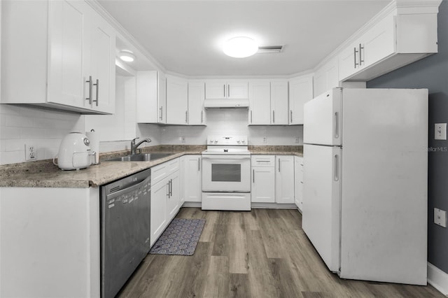 629 Lexington St, Dunedin, FL 34698 - kitchen with white appliances, under cabinet range hood, wood finished floors, and white cabinetry