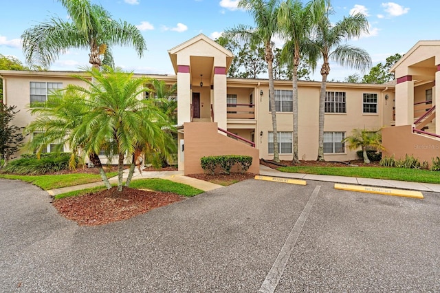 view of property with uncovered parking