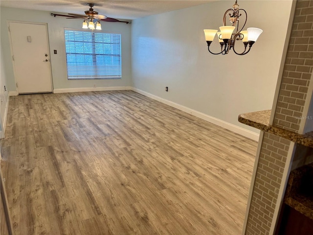 1020 85th Ave N Unit 223, Saint Petersburg, FL 33702 - unfurnished dining area featuring wood finished floors, ceiling fan, a chandelier, and baseboards