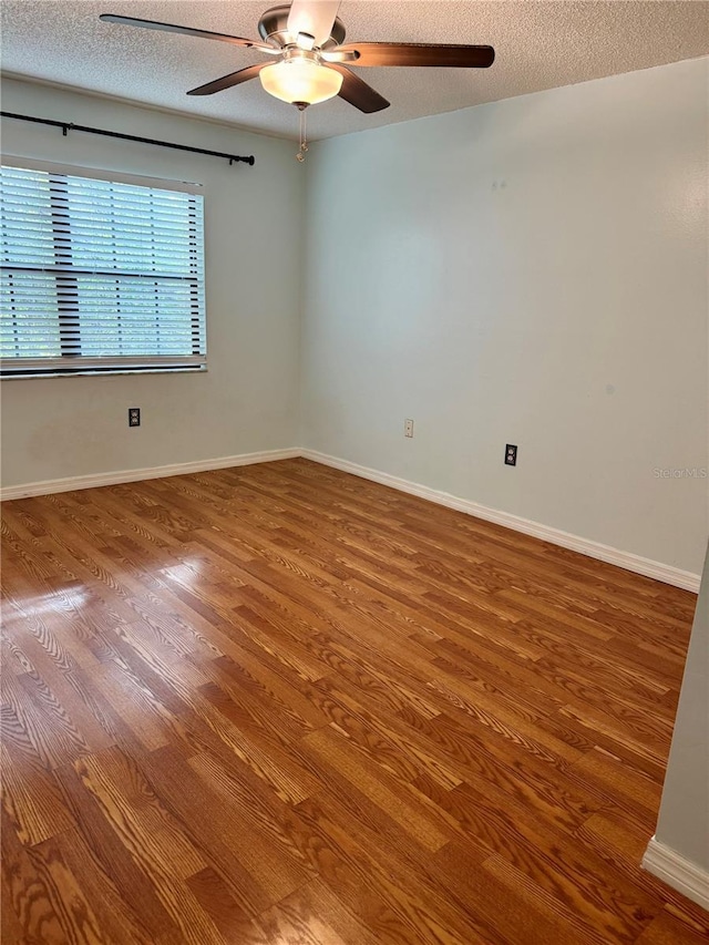 1020 85th Ave N Unit 223, Saint Petersburg, FL 33702 - empty room with wood finished floors, a ceiling fan, and a textured ceiling