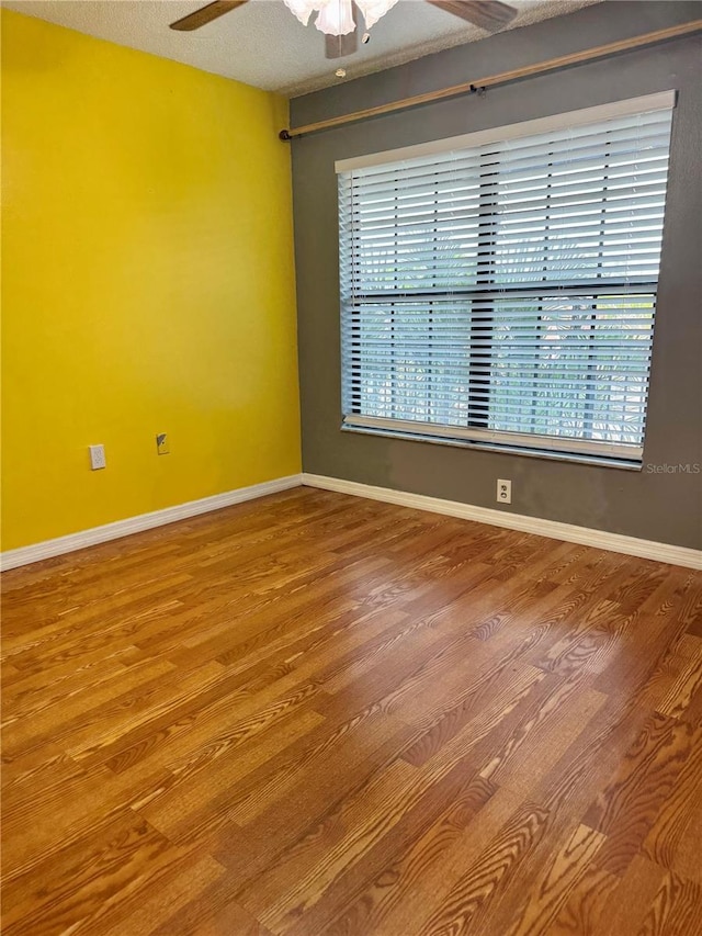 1020 85th Ave N Unit 223, Saint Petersburg, FL 33702 - empty room featuring a ceiling fan, wood finished floors, and baseboards