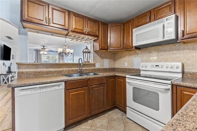 1020 85th Ave N Unit 223, Saint Petersburg, FL 33702 - kitchen featuring white appliances, a sink, and brown cabinetry