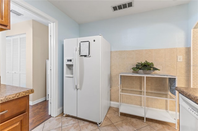 1020 85th Ave N Unit 223, Saint Petersburg, FL 33702 - kitchen featuring white appliances, light tile patterned flooring, and brown cabinets