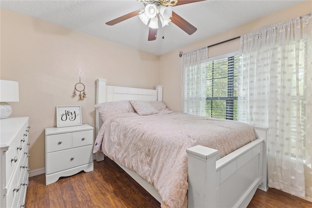 1020 85th Ave N Unit 223, Saint Petersburg, FL 33702 - bedroom featuring dark wood-style flooring, a ceiling fan, and baseboards