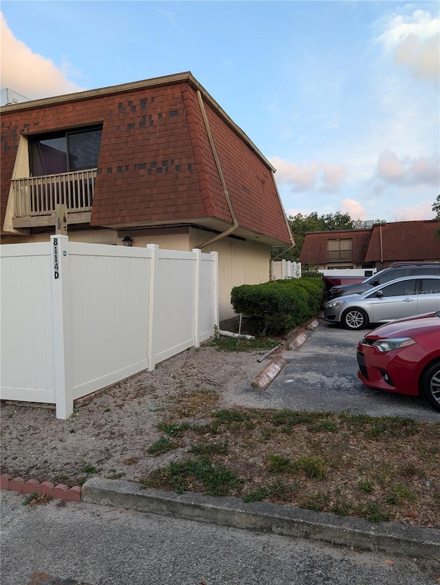 8114 Oak Trace Way Unit D, Tampa, FL 33634 - view of property exterior with mansard roof
