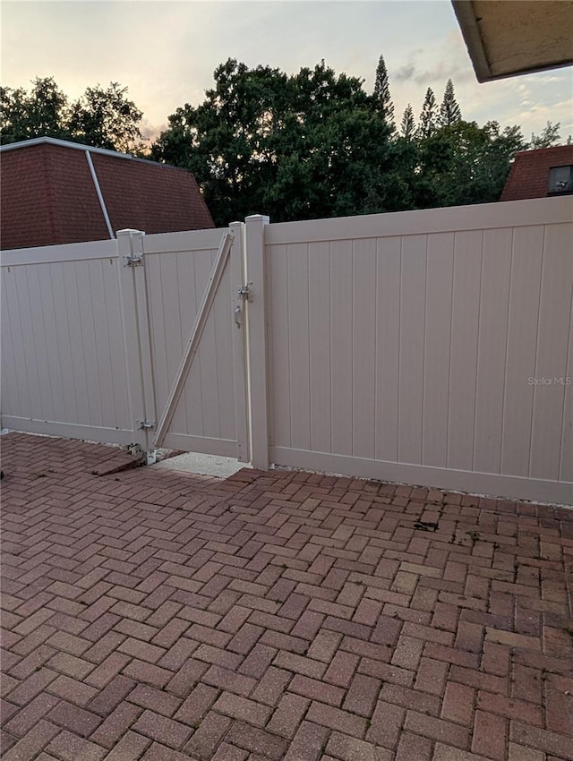 8114 Oak Trace Way Unit D, Tampa, FL 33634 - patio terrace at dusk featuring a gate