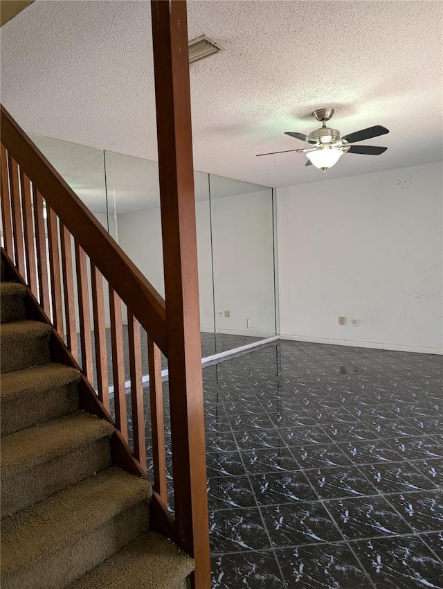 8114 Oak Trace Way Unit D, Tampa, FL 33634 - stairway with ceiling fan and a textured ceiling