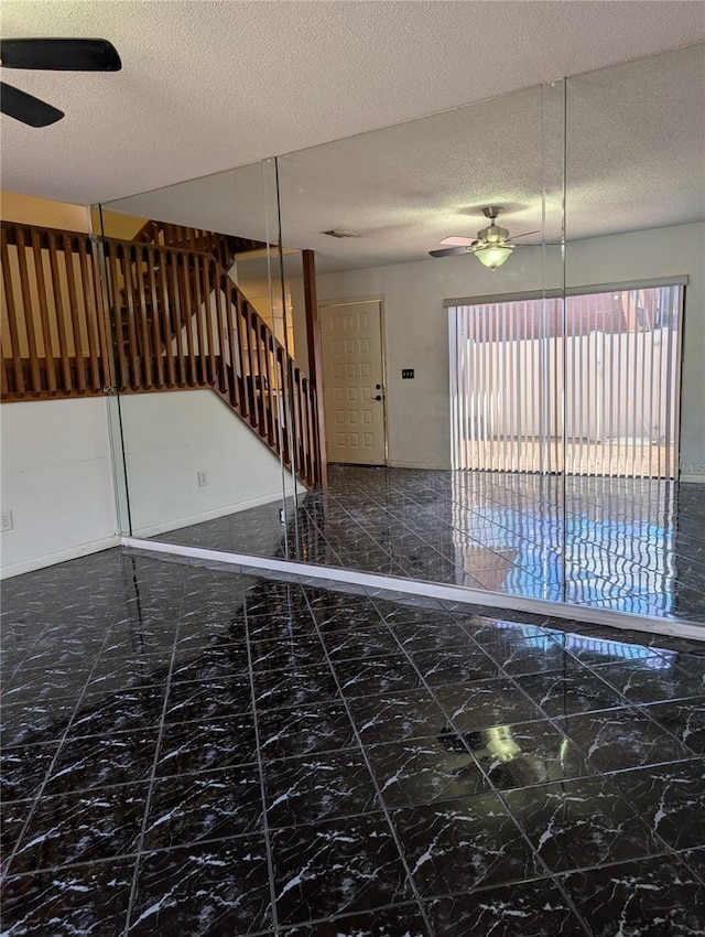 8114 Oak Trace Way Unit D, Tampa, FL 33634 - staircase with ceiling fan, marble look tile flooring, and a textured ceiling