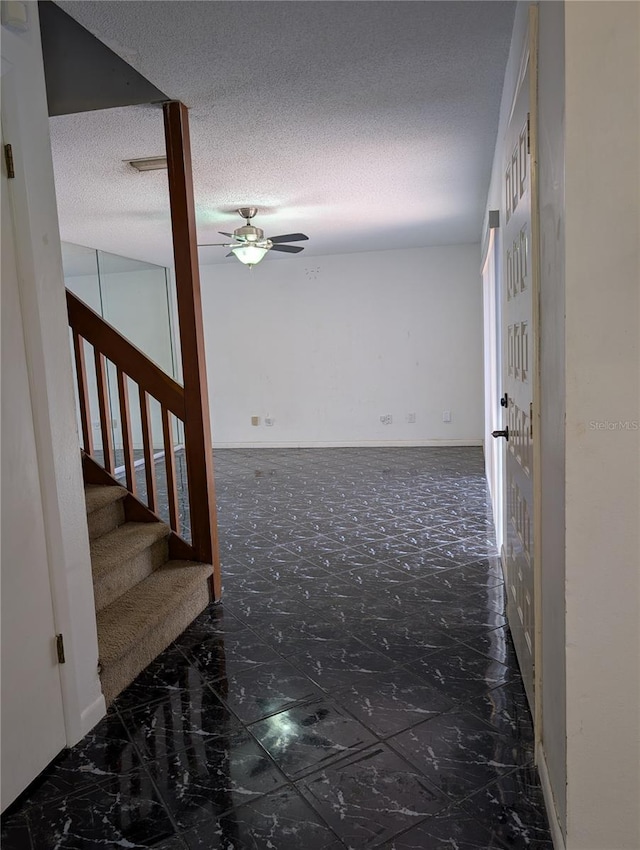 8114 Oak Trace Way Unit D, Tampa, FL 33634 - hallway featuring stairway, marble finish floors, and a textured ceiling