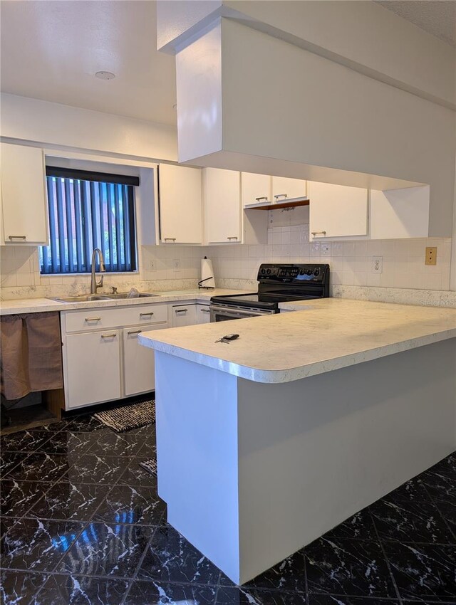 8114 Oak Trace Way Unit D, Tampa, FL 33634 - kitchen featuring black range with electric cooktop, a sink, dark marble finish flooring, and light countertops