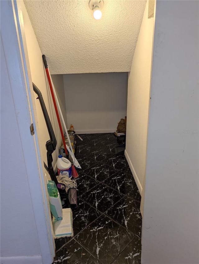 8114 Oak Trace Way Unit D, Tampa, FL 33634 - hall with marble finish floors, a textured ceiling, and baseboards