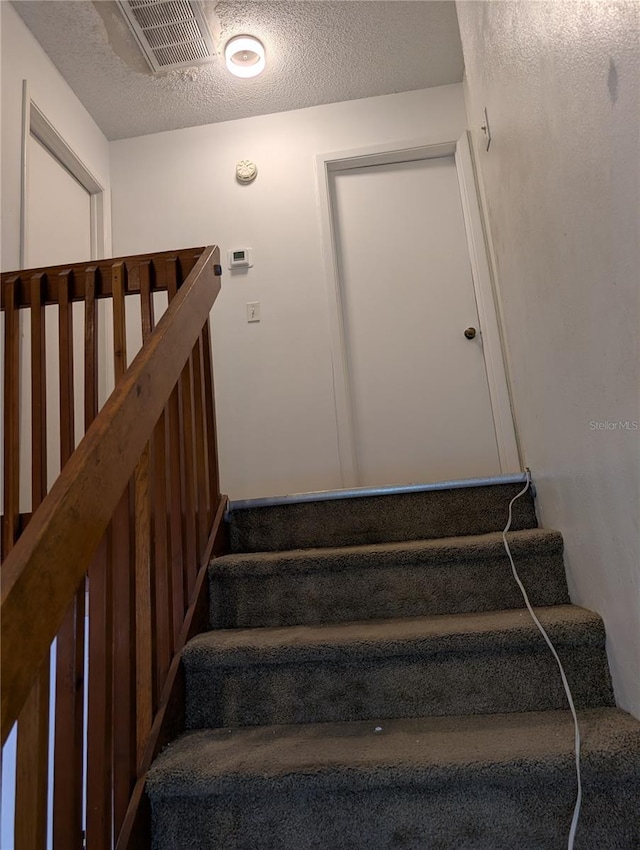 8114 Oak Trace Way Unit D, Tampa, FL 33634 - staircase with a textured ceiling