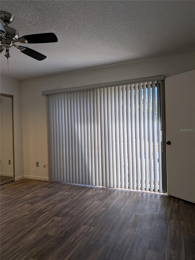 8114 Oak Trace Way Unit D, Tampa, FL 33634 - empty room with wood finished floors, a ceiling fan, baseboards, and a textured ceiling
