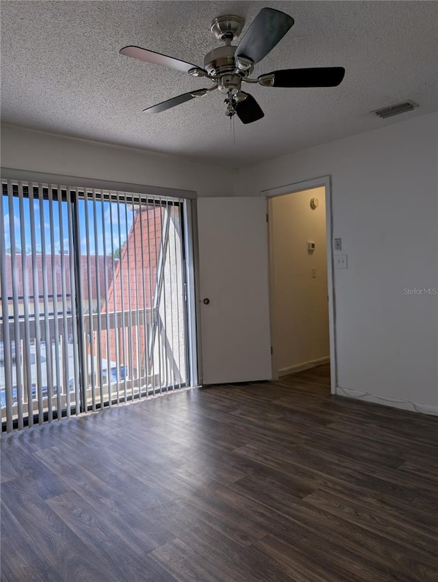 8114 Oak Trace Way Unit D, Tampa, FL 33634 - empty room featuring wood finished floors, a ceiling fan, and a textured ceiling