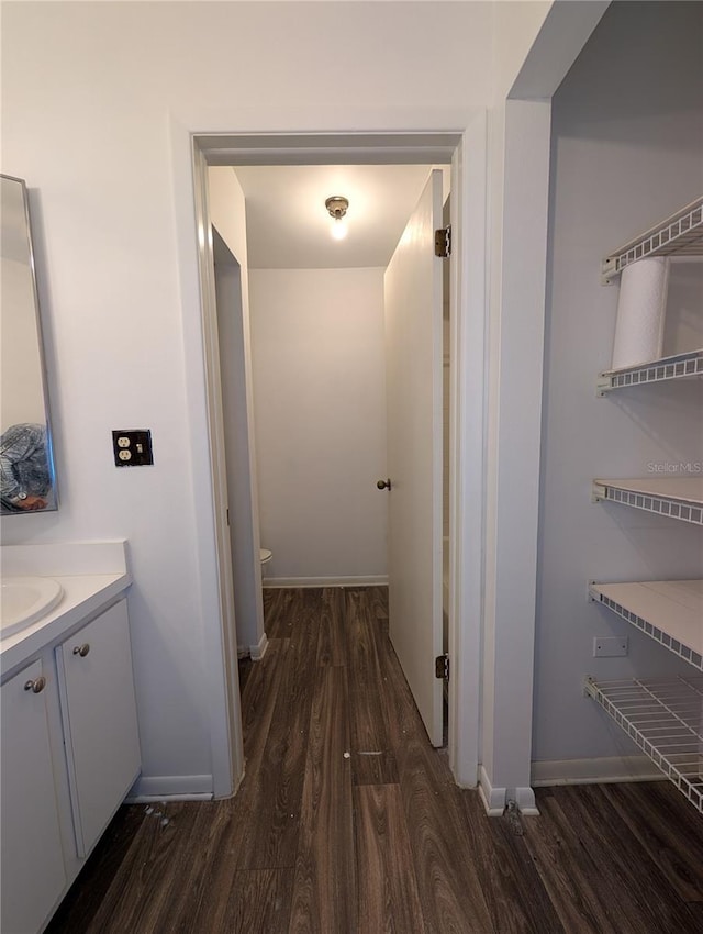 8114 Oak Trace Way Unit D, Tampa, FL 33634 - bathroom featuring wood finished floors, vanity, toilet, and baseboards