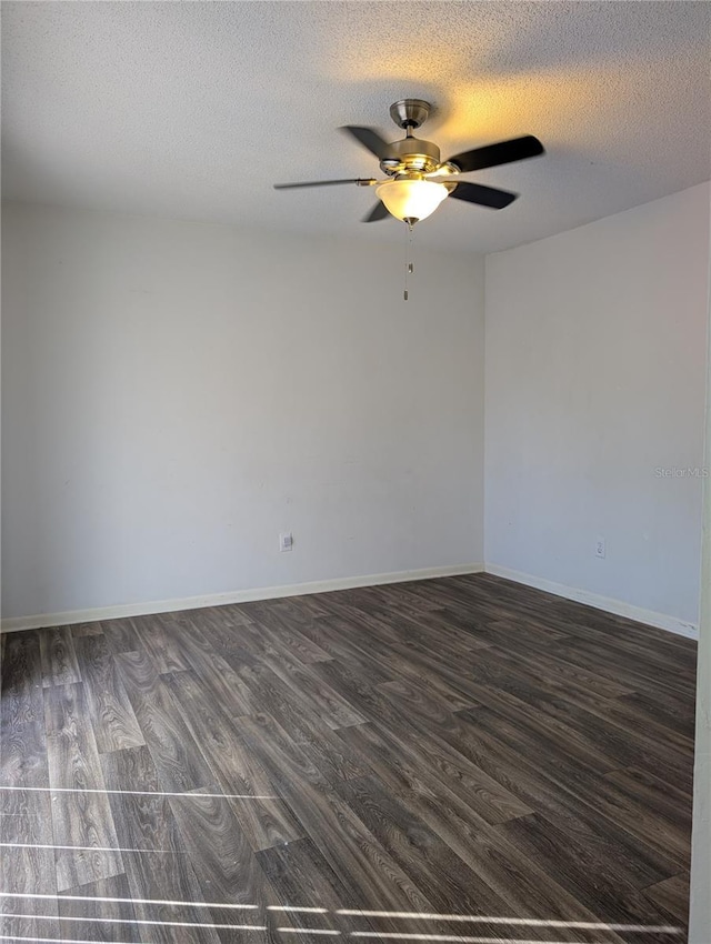 8114 Oak Trace Way Unit D, Tampa, FL 33634 - empty room with a ceiling fan, dark wood-style floors, a textured ceiling, and baseboards