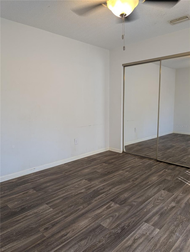 8114 Oak Trace Way Unit D, Tampa, FL 33634 - unfurnished bedroom with wood finished floors, a closet, baseboards, and ceiling fan