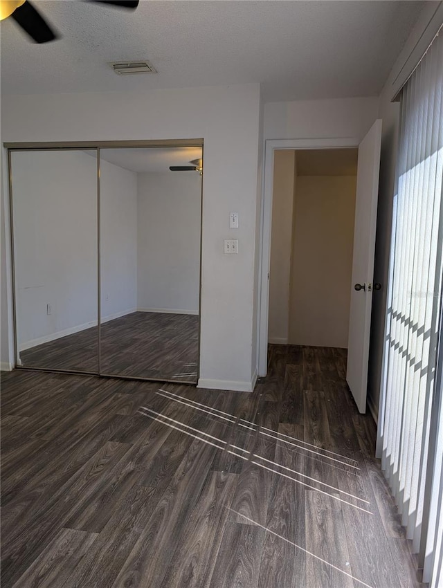 8114 Oak Trace Way Unit D, Tampa, FL 33634 - unfurnished bedroom with multiple windows, wood finished floors, a closet, and baseboards