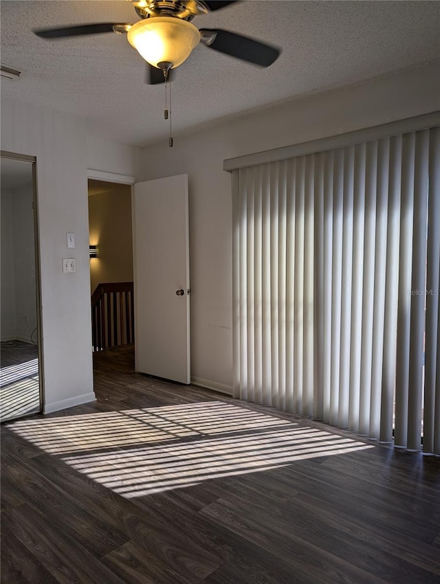 8114 Oak Trace Way Unit D, Tampa, FL 33634 - empty room with wood finished floors, ceiling fan, baseboards, and a textured ceiling
