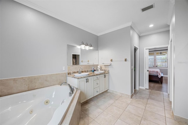 ensuite bathroom featuring crown molding, a jetted tub, double vanity, tile patterned floors, and baseboards
