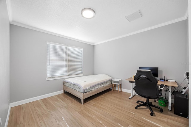 bedroom featuring ornamental molding, light wood-type flooring, baseboards, and an office area
