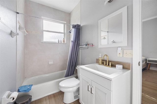 full bathroom with wood finished floors, toilet, shower / tub combo, and vanity