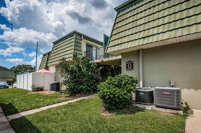 1799 N Highland Ave Unit 106, Clearwater, FL 33755 - view of side of home featuring central air condition unit, mansard roof, and a balcony