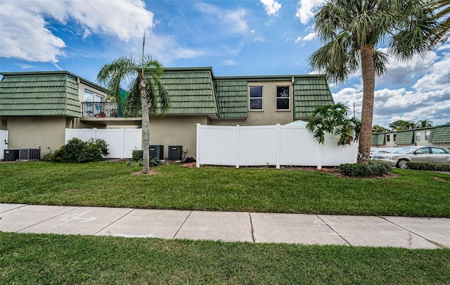 1799 N Highland Ave Unit 106, Clearwater, FL 33755 - view of front of house with mansard roof, stucco siding, and central AC