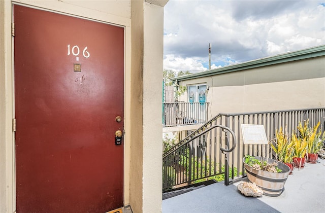 1799 N Highland Ave Unit 106, Clearwater, FL 33755 - property entrance featuring stucco siding and a balcony