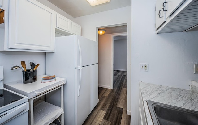 1799 N Highland Ave Unit 106, Clearwater, FL 33755 - kitchen featuring electric range, freestanding refrigerator, dark wood-type flooring, and white cabinets