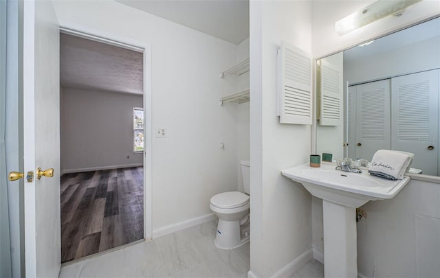 1799 N Highland Ave Unit 106, Clearwater, FL 33755 - bathroom featuring toilet, a closet, and baseboards