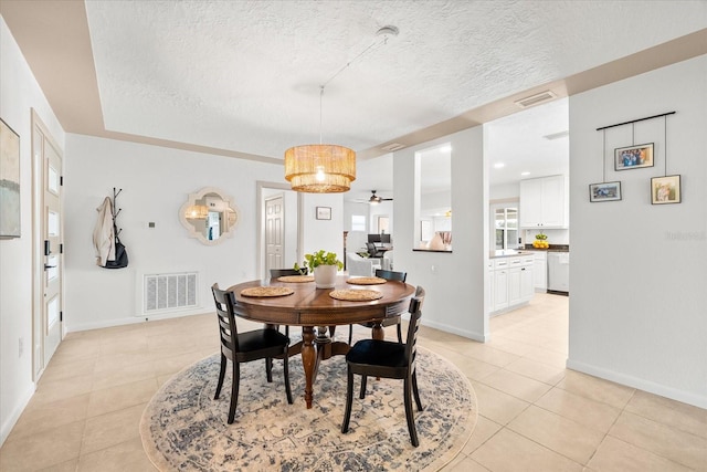 8848 Sunlit Cove Dr NE, Saint Petersburg, FL 33702 - dining area with a textured ceiling, light tile patterned floors, ceiling fan, and baseboards