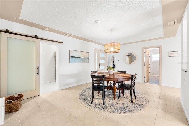 8848 Sunlit Cove Dr NE, Saint Petersburg, FL 33702 - dining room featuring a barn door, a textured ceiling, light tile patterned floors, baseboards, and a chandelier