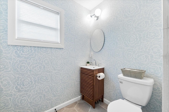 8848 Sunlit Cove Dr NE, Saint Petersburg, FL 33702 - bathroom featuring vanity, toilet, tile patterned floors, and baseboards