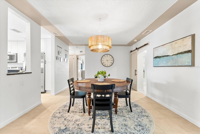 8848 Sunlit Cove Dr NE, Saint Petersburg, FL 33702 - dining area featuring a barn door, light tile patterned floors, baseboards, a textured ceiling, and a chandelier