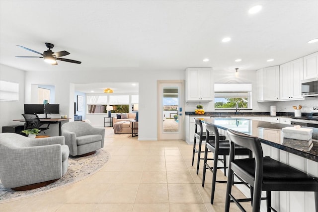 8848 Sunlit Cove Dr NE, Saint Petersburg, FL 33702 - living room featuring recessed lighting, light tile patterned flooring, and a ceiling fan