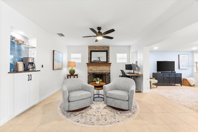 8848 Sunlit Cove Dr NE, Saint Petersburg, FL 33702 - living room with light tile patterned floors, a stone fireplace, ceiling fan, baseboards, and recessed lighting