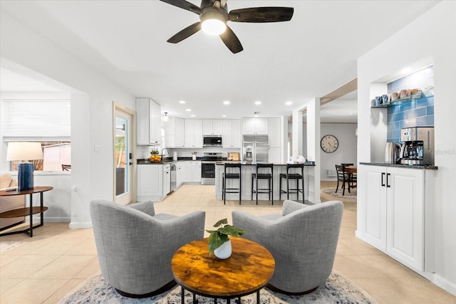8848 Sunlit Cove Dr NE, Saint Petersburg, FL 33702 - living room with light tile patterned floors, ceiling fan, baseboards, and recessed lighting