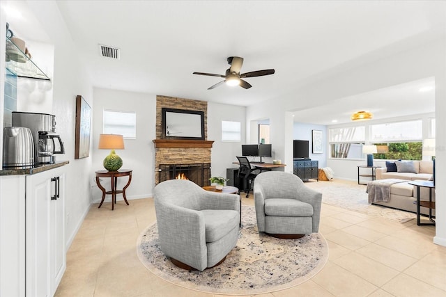 8848 Sunlit Cove Dr NE, Saint Petersburg, FL 33702 - living area with a fireplace, light tile patterned floors, healthy amount of natural light, and ceiling fan
