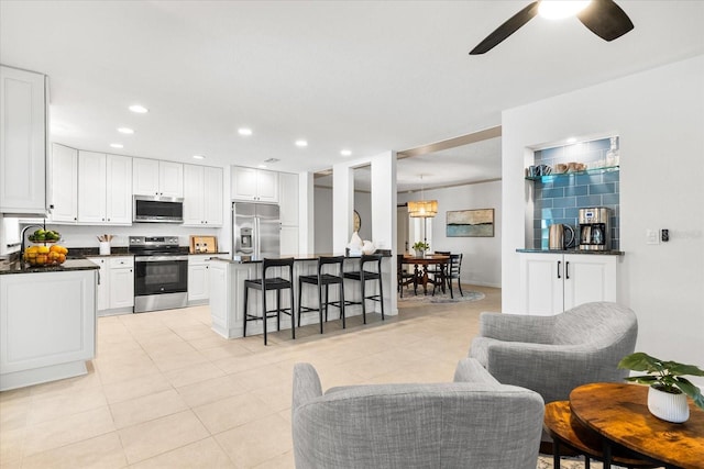 8848 Sunlit Cove Dr NE, Saint Petersburg, FL 33702 - living room featuring a ceiling fan, light tile patterned floors, and recessed lighting