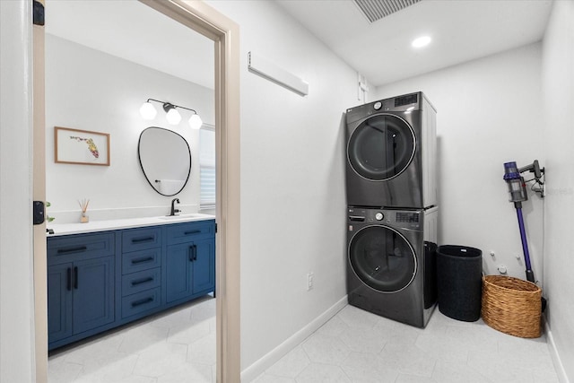 8848 Sunlit Cove Dr NE, Saint Petersburg, FL 33702 - laundry room with estacked washer and dryer, recessed lighting, and light tile patterned floors