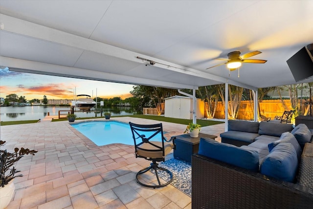 8848 Sunlit Cove Dr NE, Saint Petersburg, FL 33702 - view of swimming pool featuring boat lift, an outdoor living space, a water view, a patio, and a dock