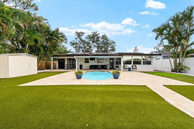 8848 Sunlit Cove Dr NE, Saint Petersburg, FL 33702 - back of house with a patio, solar panels, and a chimney
