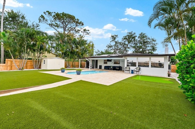 8848 Sunlit Cove Dr NE, Saint Petersburg, FL 33702 - back of house featuring a patio, roof mounted solar panels, and an area to practice putting