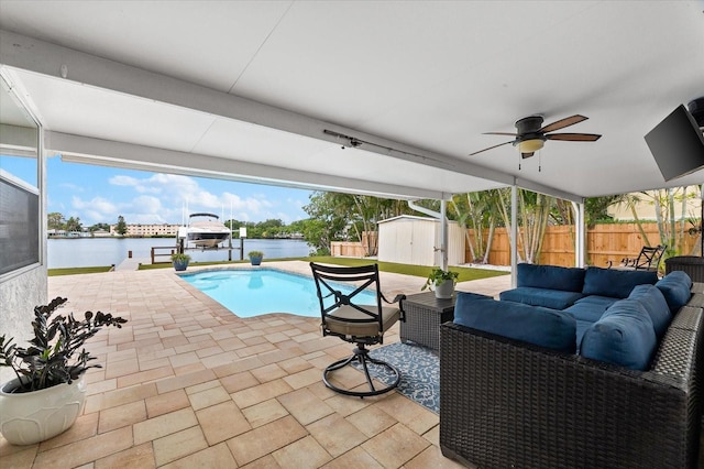 8848 Sunlit Cove Dr NE, Saint Petersburg, FL 33702 - view of swimming pool with an outdoor living space, a patio area, a fenced backyard, a ceiling fan, and boat lift
