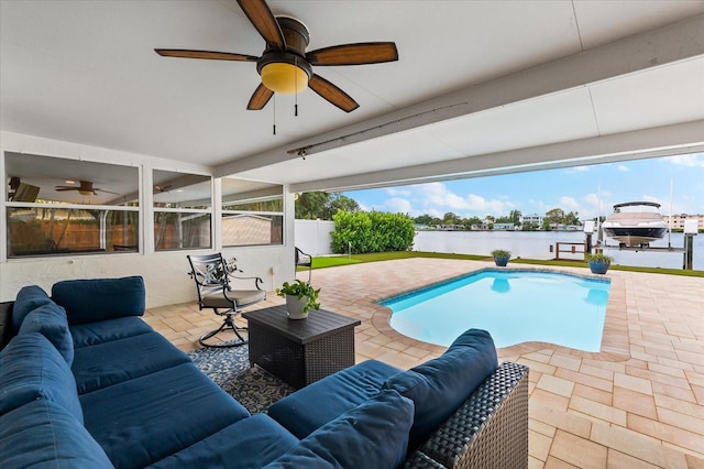 8848 Sunlit Cove Dr NE, Saint Petersburg, FL 33702 - outdoor pool with an outdoor hangout area, a water view, a ceiling fan, and a patio