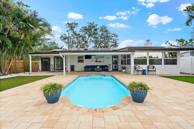 8848 Sunlit Cove Dr NE, Saint Petersburg, FL 33702 - rear view of property featuring an outdoor living space, solar panels, stucco siding, a patio area, and a fenced backyard